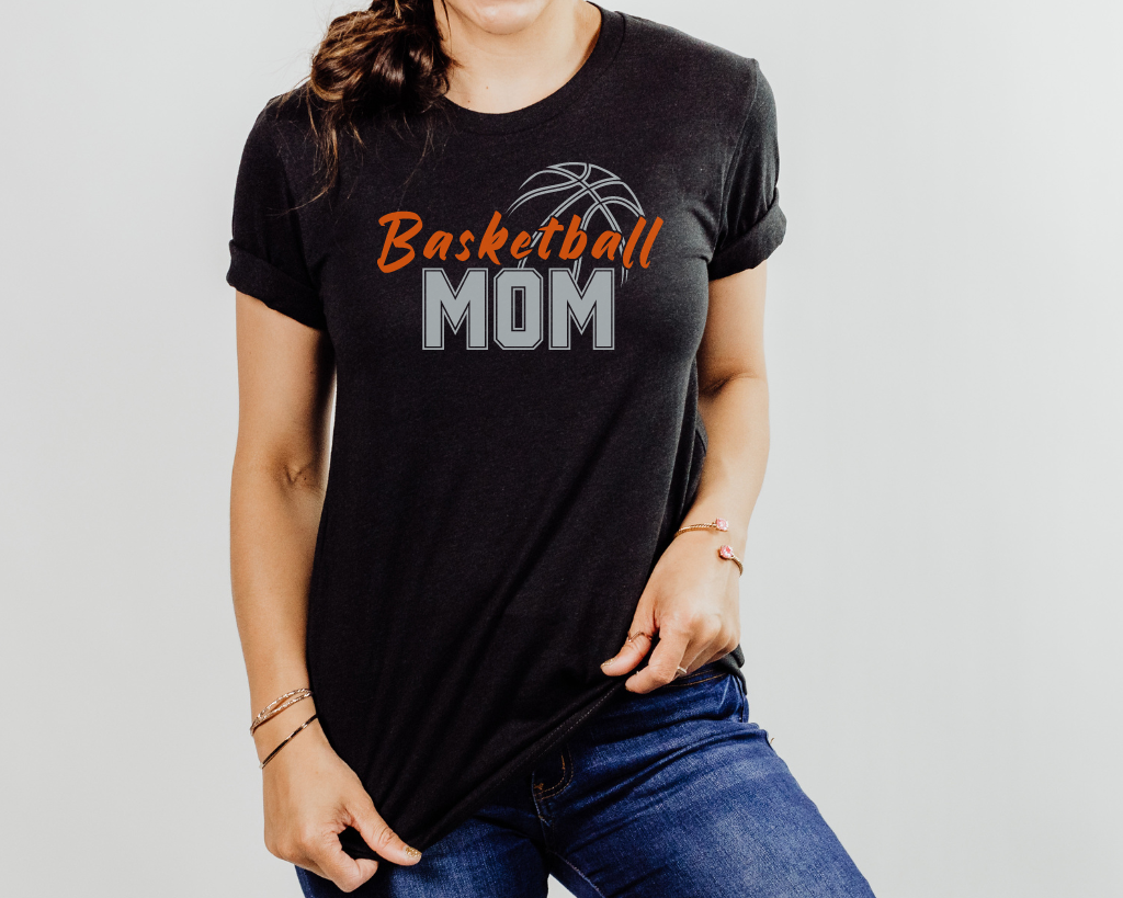 Black basketball mom shirt with 'Basketball' in orange letters, 'Mom' in silver letters, and a basketball outline above the word 'Basketball.