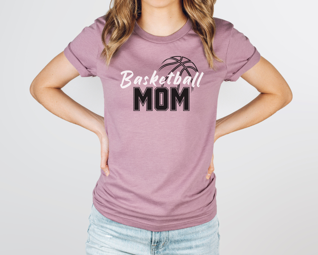 Pink basketball mom shirt with 'Basketball' in white letters, 'Mom' in black letters, and a basketball outline above the word 'Basketball.