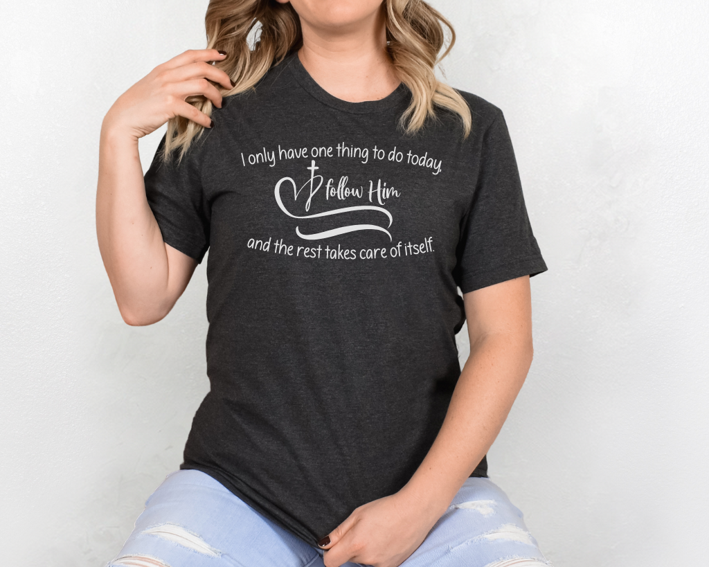 Christian dark gray shirt white lettering "I only have one thing to do today, follow him, and the rest takes care of itself" with white heart & cross