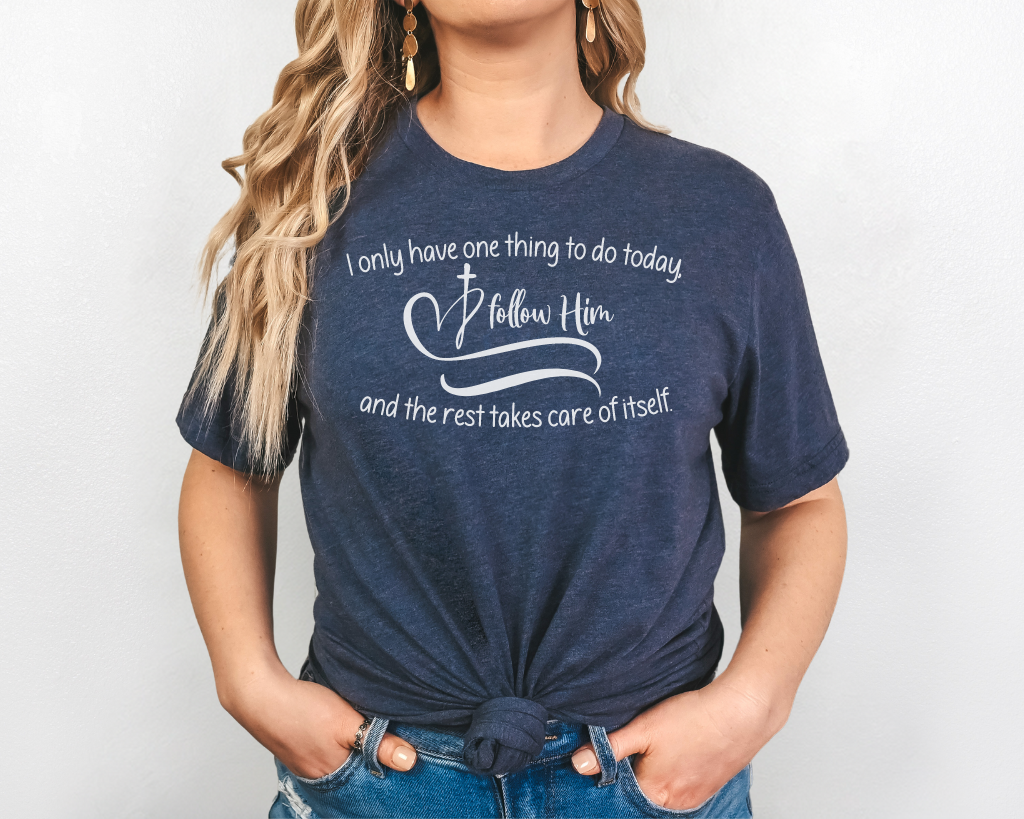 Christian navy shirt white lettering "I only have one thing to do today, follow him, and the rest takes care of itself" with white heart & cross